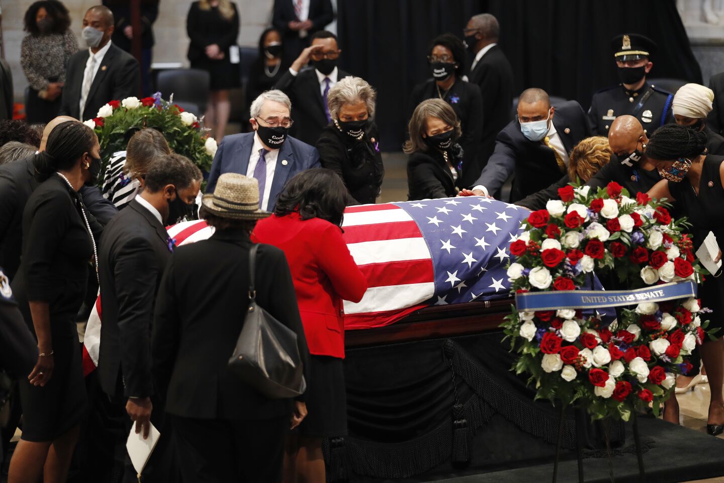 People pay respects to Rep. John Lewis, D-Ga., as he lies in state in the Capitol Rotunda, Monday in Washington.