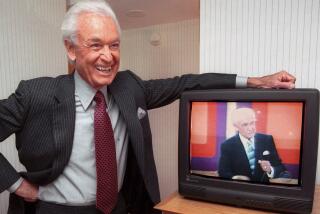 FILE - Legendary game show host Bob Barker, 73, leans on his hotel room television showing his image, during an interview Monday, Oct. 23, 2000 in Cambridge, Mass. (AP Photo/Michael Dwyer, File)