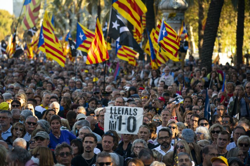 Protesters hold ''esteladas'' or Catalonia independence flag as they take part in a demonstration to commemorate the fifth anniversary of an independence referendum that marked the high point of their movement to break away from the rest of Spain, in Barcelona, Spain, Saturday, Oct. 1, 2022. (AP Photo/Joan Mateu Parra)