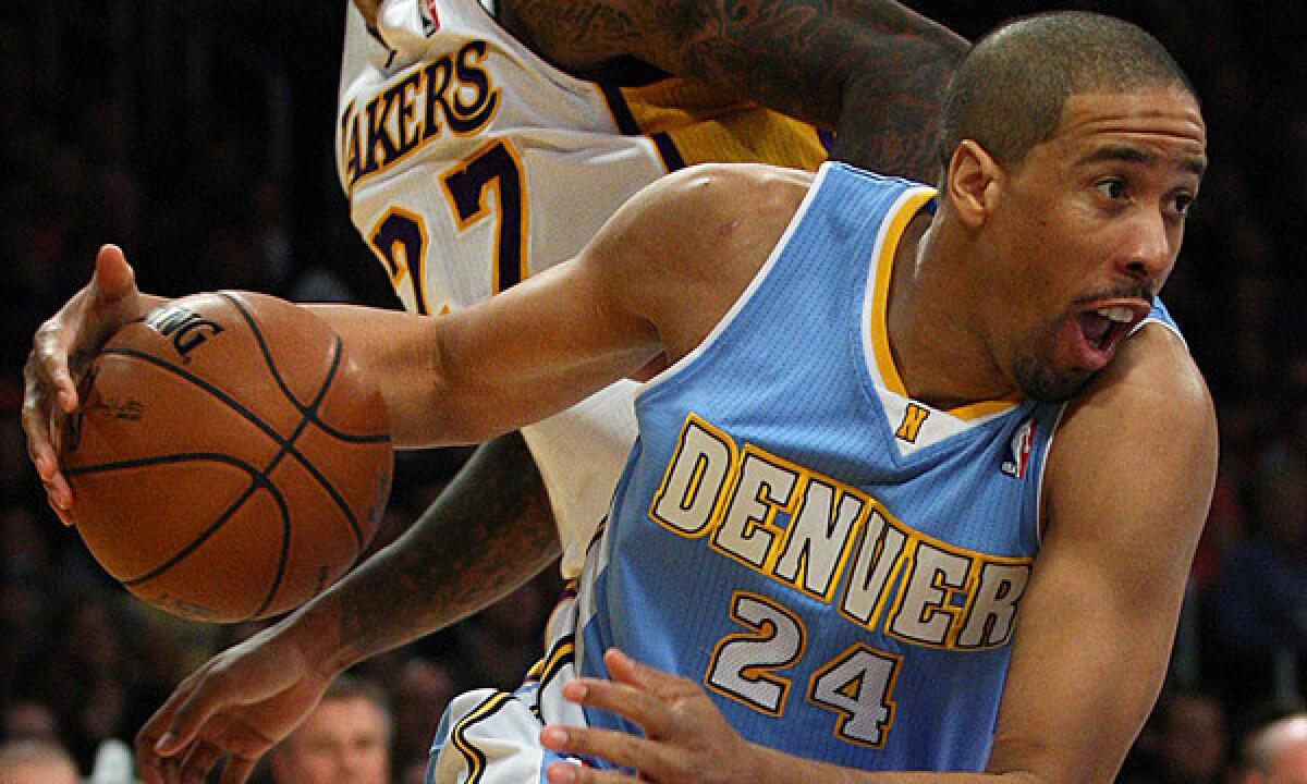 Nuggets guard Andre Miller drives past Lakers defender Jordan Hill.