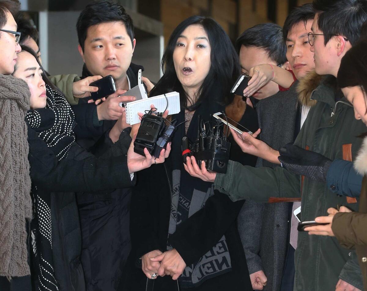 California resident Eun-mi Shin talks to reporters at the District Prosecutors' Office in Seoul, South Korea.