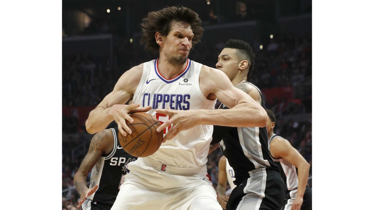 Clippers center Boban Marjanovic spins to the basket against Spurs guard Danny Green in the second quarter.