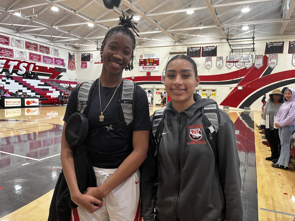 Westchester girls' basketball standouts Mariah Blake and Rylei Waugh smile in a gymnasium.
