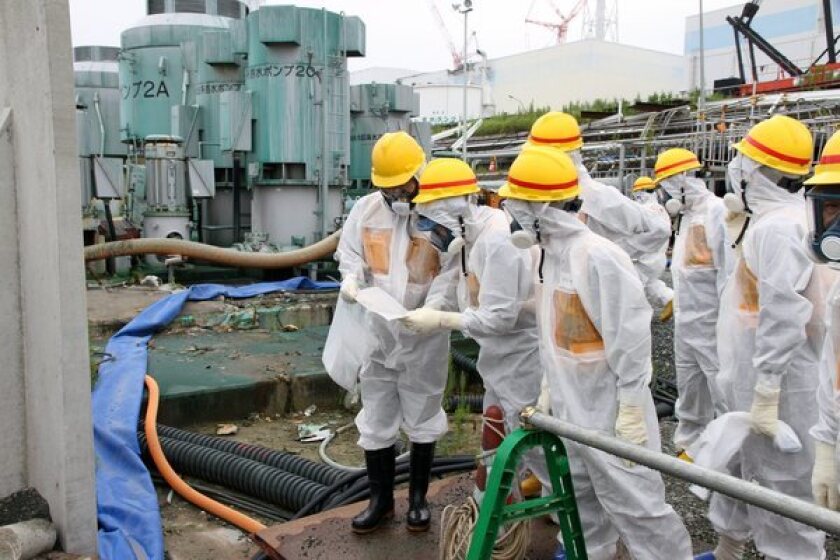 Scientists in protective suits inspect the Fukushima power plant after the 2011 earthquake. Radiation contamination has sparked worries about the safety of West Coast seafood.