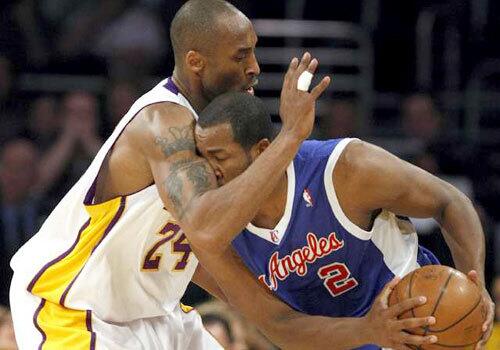 Lakers guard Kobe Bryant gets up close while playing defense on Clippers guard Fred Jones in the first quarter Sunday.