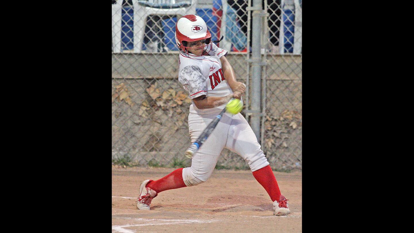 Burroughs' Destiny Velazquez hits a three-run triple in the sixth inning against Burbank in a rival Pacific League softball game at Olive Park in Burbank on Monday, May 8, 2016.