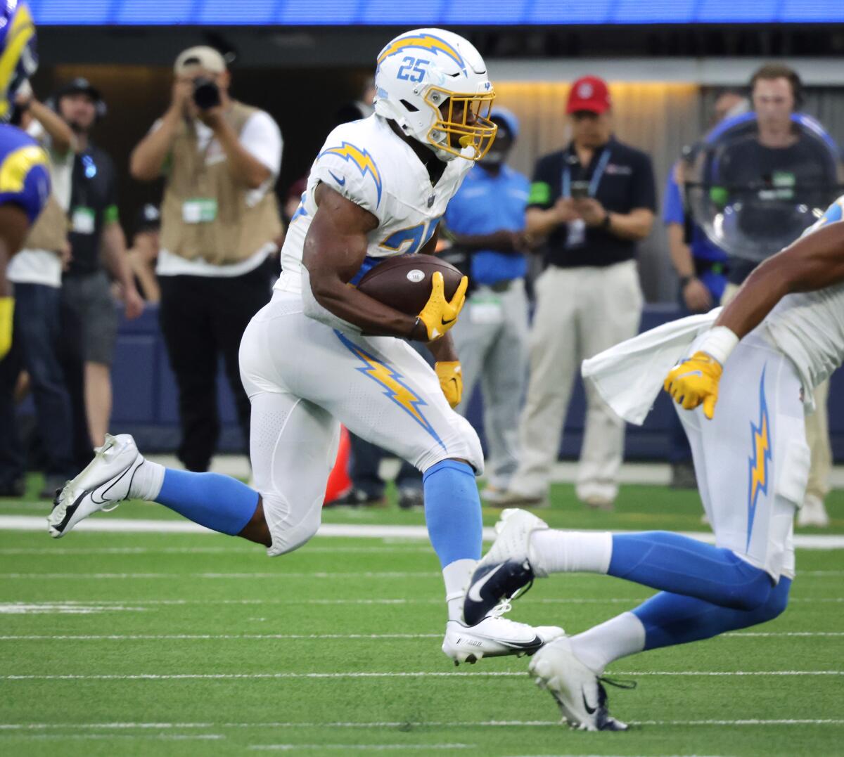 Chargers running back Joshua Kelley scrambles in the second quarter against the Rams on Saturday.