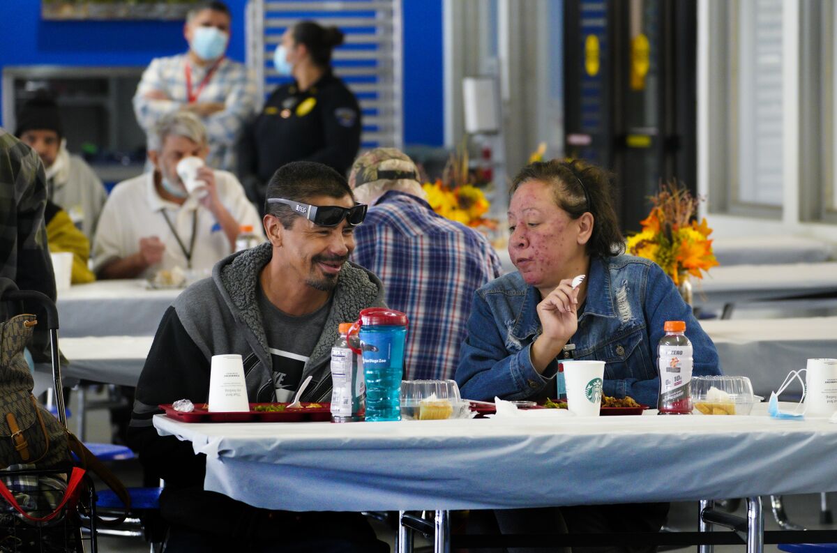 Arturo and Natalie Aranda enjoy a turkey lunch at Father Joe's Villages annual Thanksgiving event Wednesday.