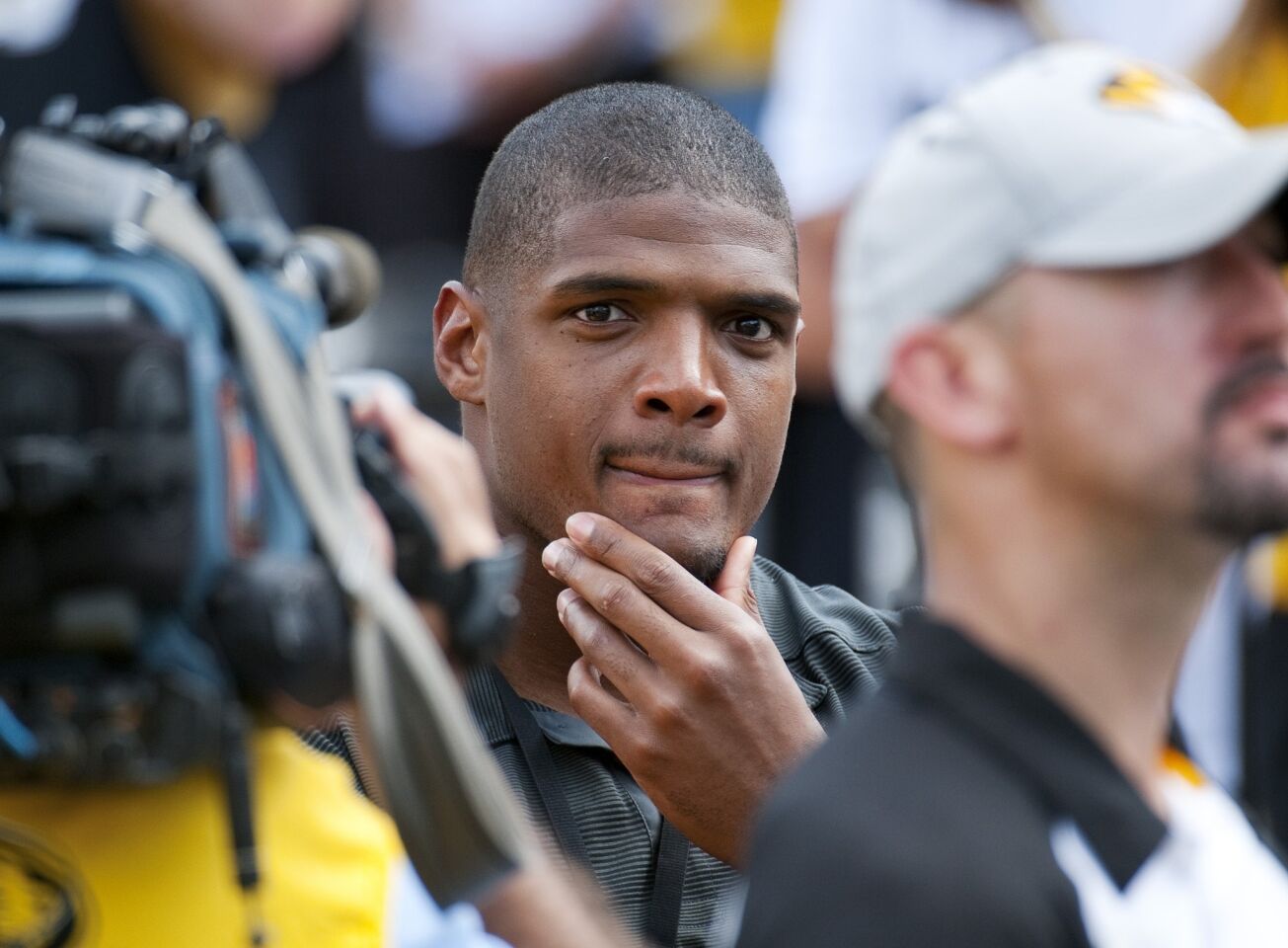Michael Sam watches pregame festivities before Saturday's game between Missouri and South Dakota State. Sam told his teammates at Missouri in a private meeting before last season that he was gay.