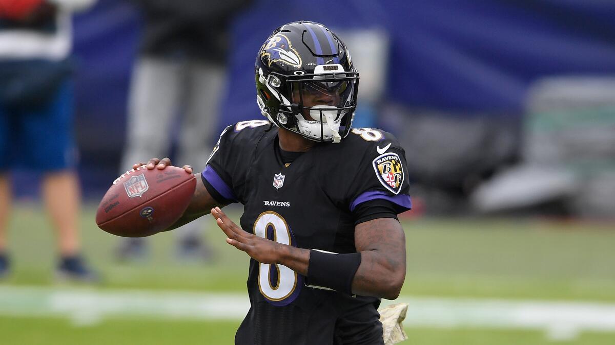 Baltimore Ravens quarterback Lamar Jackson looks to throw during a game.