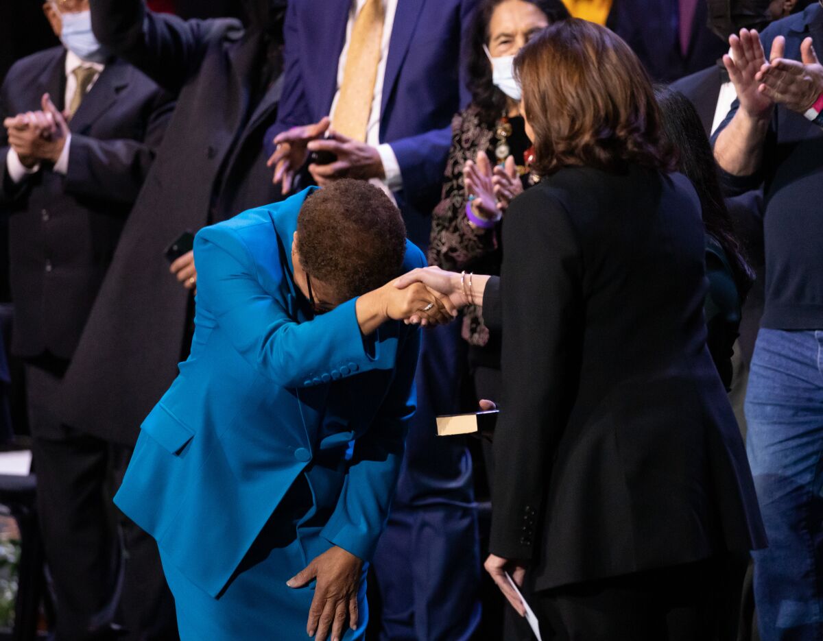  Los Angeles Mayor Karen Bass bows in appreciation to Vice President Kamala Harris 