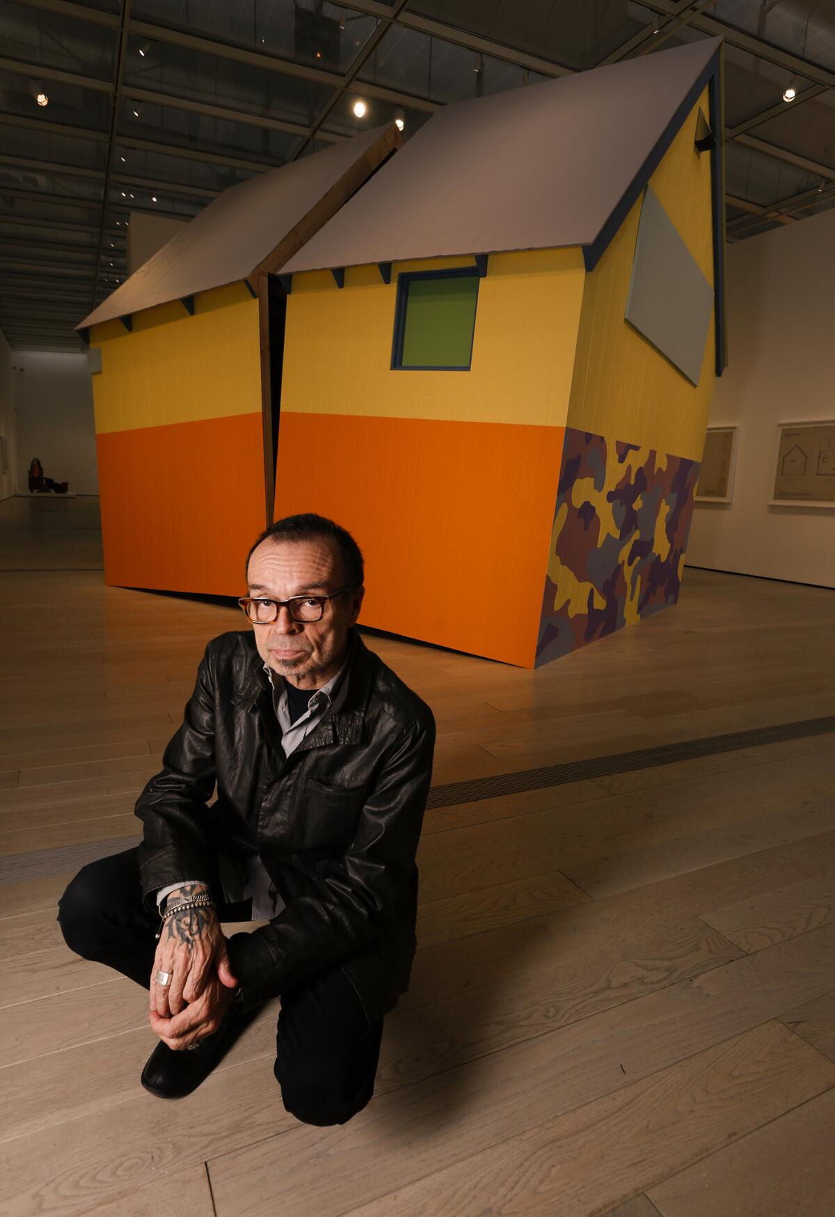 Artist Daniel Joseph Martinez with his sculpture, "The House America Built" (2004/2017), inspired by the Unabomber cabin.