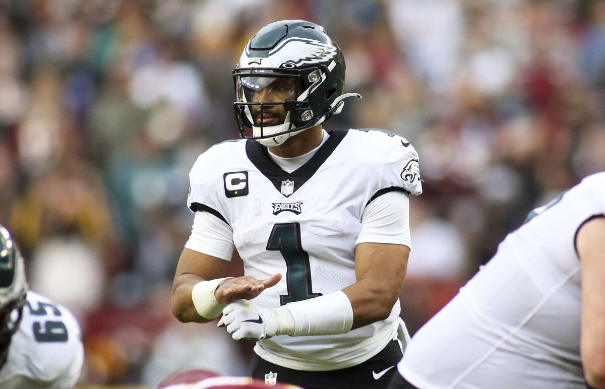 FILE - Philadelphia Eagles quarterback Jalen Hurts (1) gestures during an NFL football game against the Washington Football Team, Sunday, Jan. 2, 2022, in Landover, Md. The Eagles play the Tampa Bay Buccaneers in an NFC wild-card game on Sunday. (AP Photo/Daniel Kucin Jr., File)