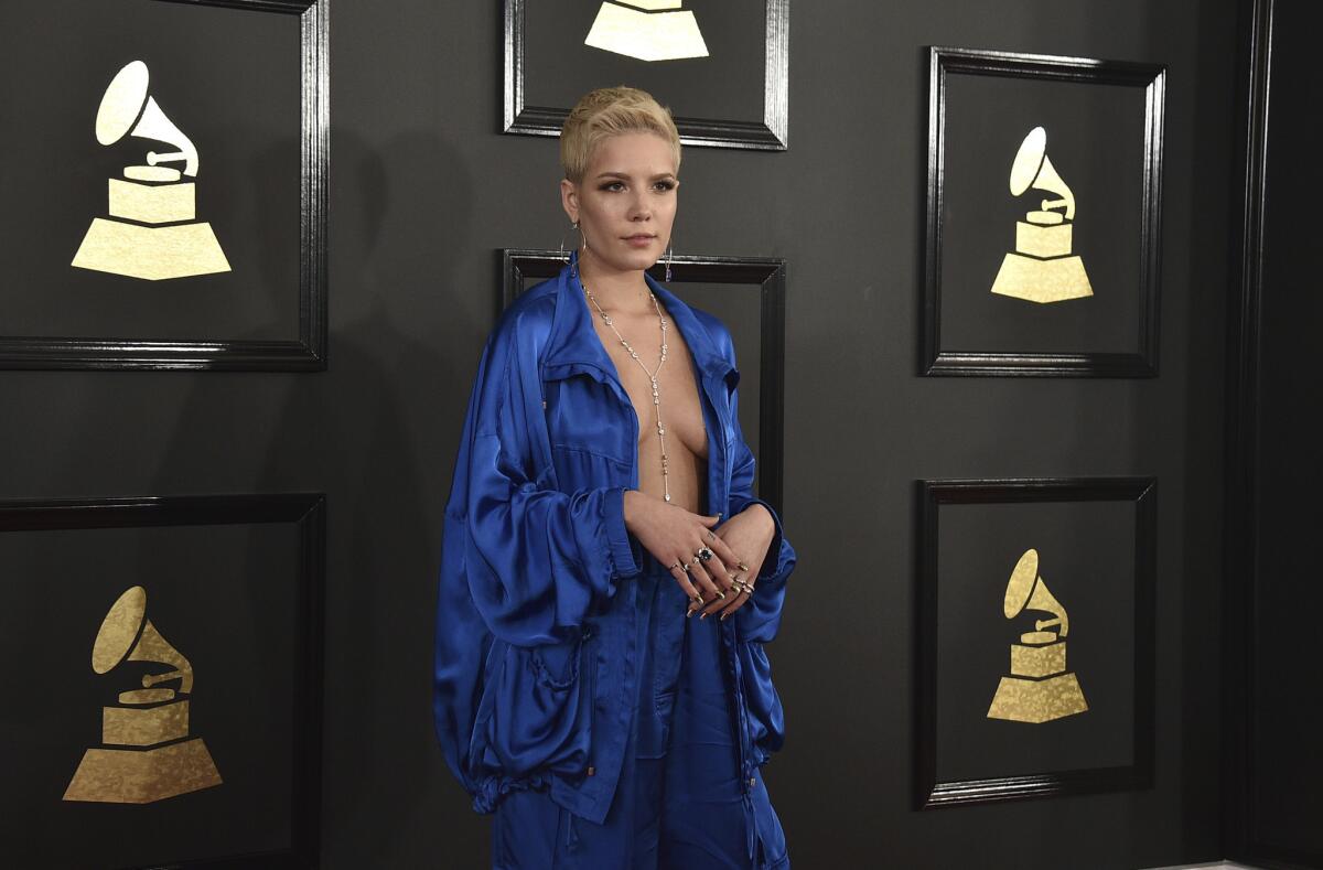 Halsey arrived at the 59th Grammy Awards in a silky blue jumpsuit. This track-inspired outfit was a worst-dressed look from the start of the race.
