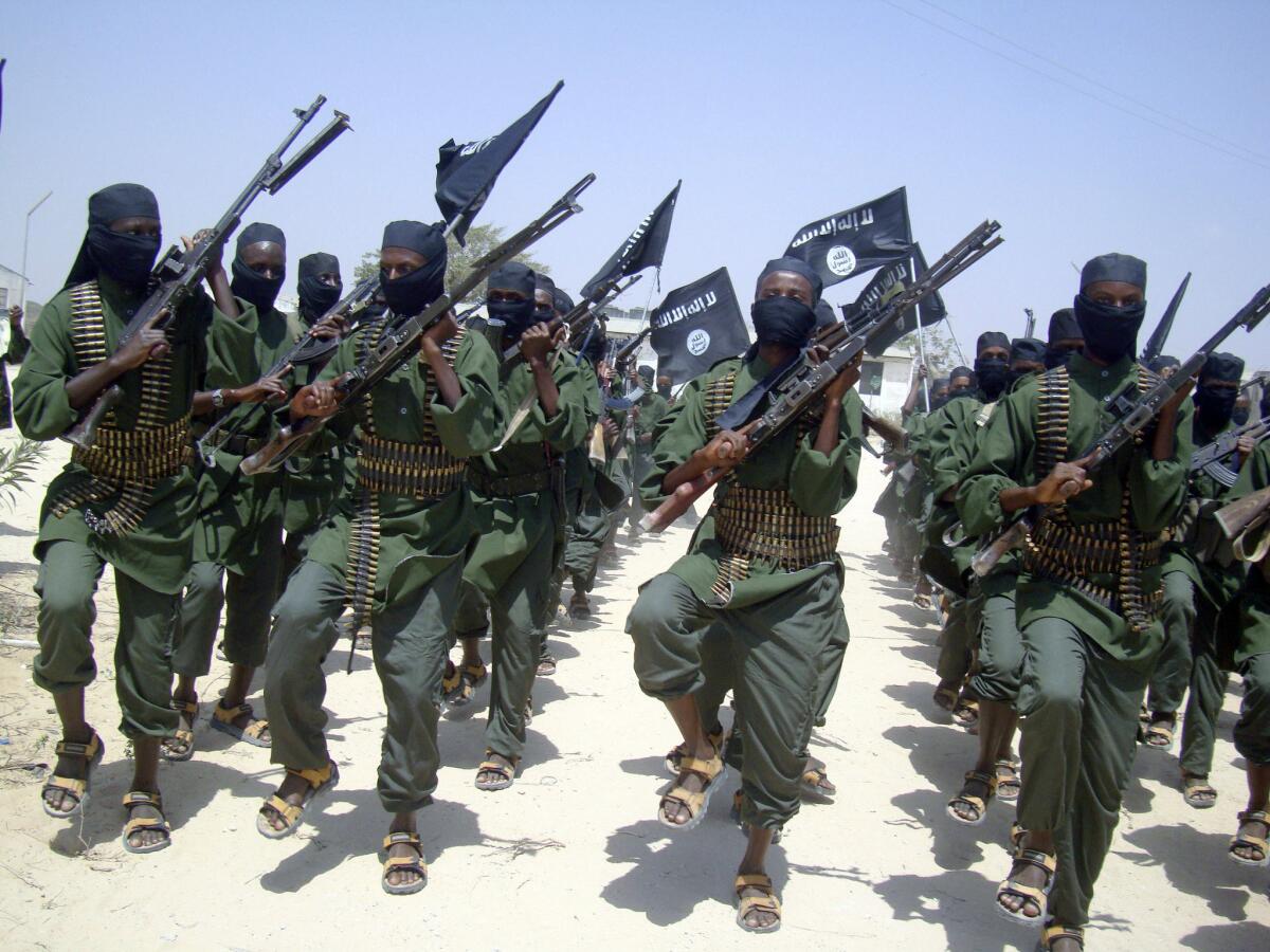 In this Feb. 17, 2011, photo, Shabab fighters march with their weapons during military exercises on the outskirts of Mogadishu, Somalia.