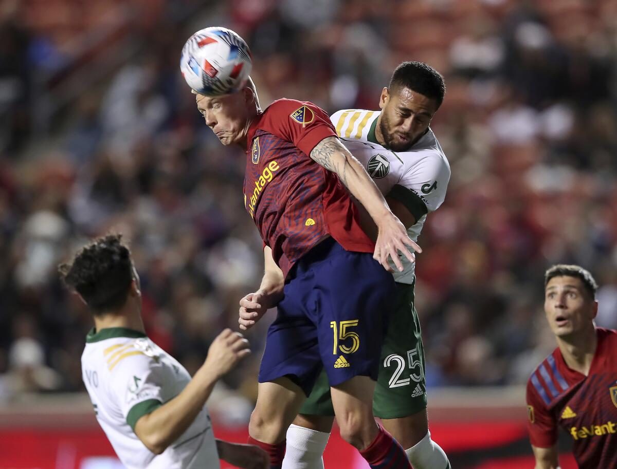 Real Salt Lake defender Justen Glad (15) and Portland Timbers defender Bill Tuiloma (25) jockey for the ball in front of the Timbers' goal during an MLS soccer match Wednesday, Nov. 3, 2021, in Sandy, Utah. (Scott G Winterton/Deseret News via AP)