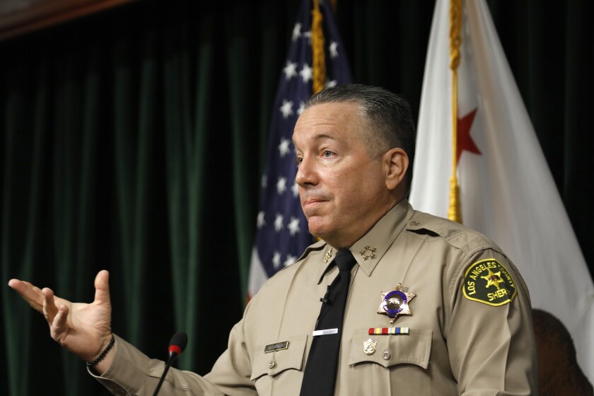 Los Angeles County Sheriff Alex Villanueva gestures while speaking.