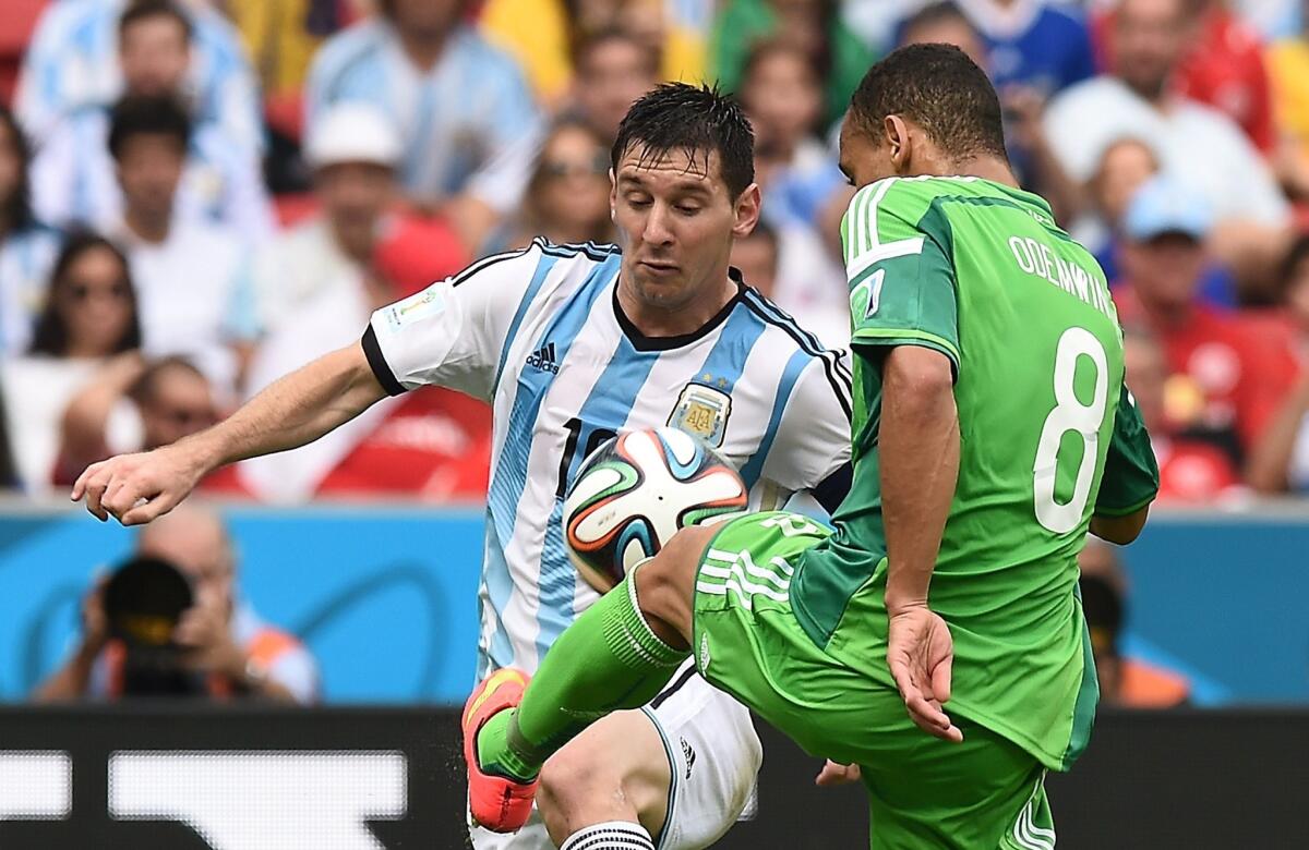 Nigeria's Peter Odemwingie, right, challenges Argentina's Lionel Messi for the ball during a Group F match Wednesday.