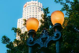 A "Broadway Rose" streetlight set against the iconic U.S. Bank Tower.