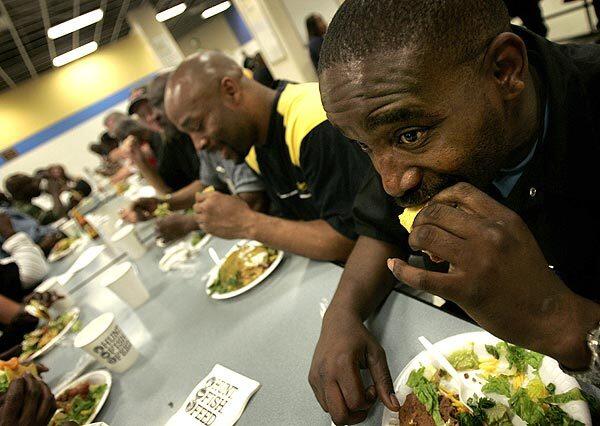 Germaine David takes a bite of a taco at the Union Rescue Mission on skid row. He is among hundreds who dined there Monday, eating bear, wild pig, venison and sheep meat donated by a huntgin group.