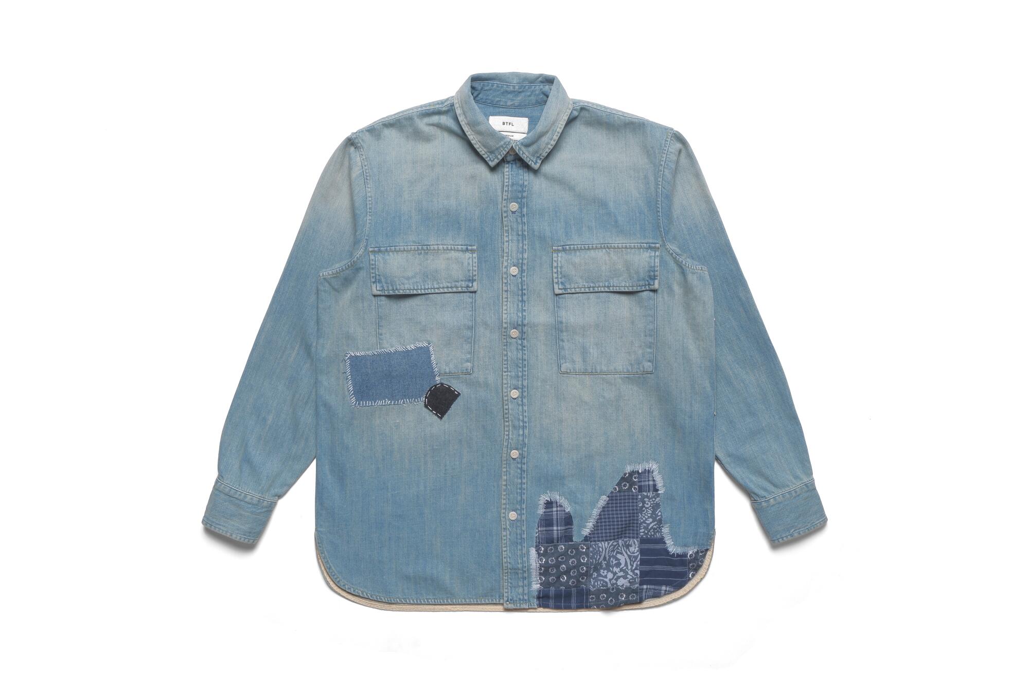 A long-sleeve denim shirt with darker denim patches