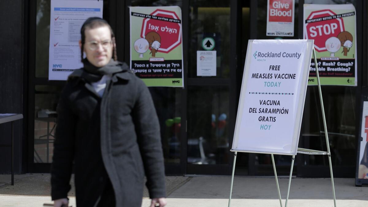 Signs advertise free measles vaccines at the Rockland County Health Department in Pomona, N.Y.