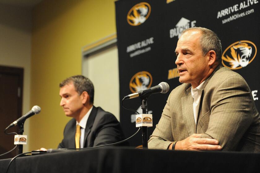 The support of Missouri Coach Gary Pinkel, right, helped bolster his players' attempts to enact change. It was a stark contrast to a similar situation at Wyoming in 1969.