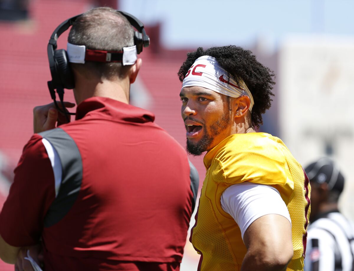 USC quarterback Caleb Williams, right, talks with coach Lincoln Riley during the Trojans' spring game April 23, 2022.