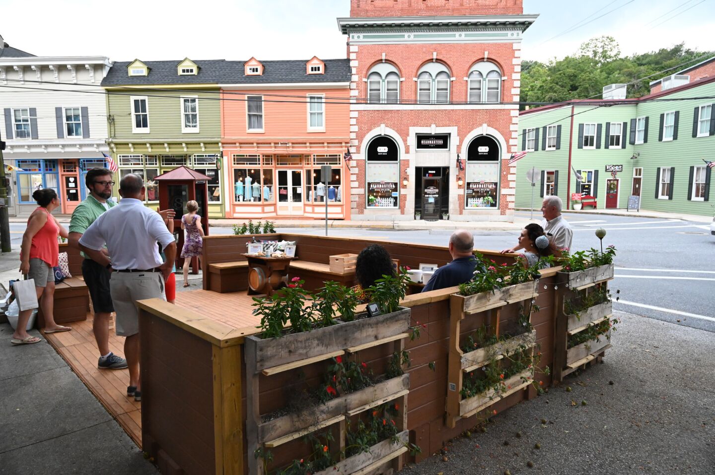 People gather to celebrate the opening of the new parklet, at the intersection of Main Street and Sandosky Road, in Sykesville on August 20.