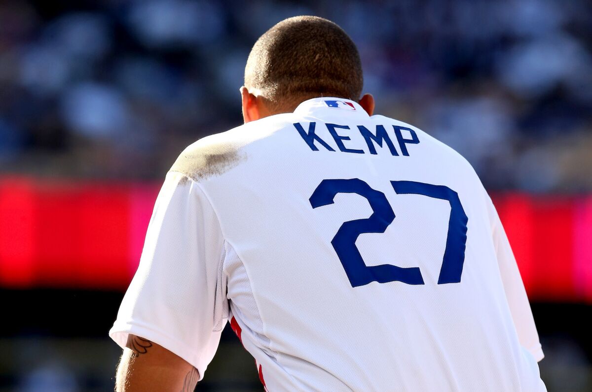Dodgers' Matt Kemp squats a first base in the fifth inning during a pitching change by the St. Louis Cardinals.