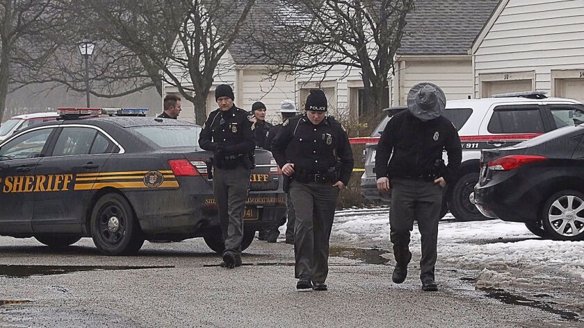 Investigators check the scene Saturday after the shooting deaths of two police officers in Westerville, Ohio.