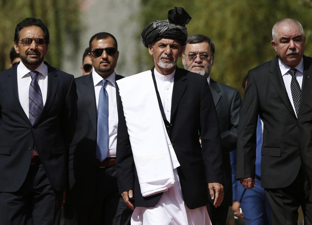 Afghanistan's new leader, Ashraf Ghani, center, arrives for his inauguration at the presidential palace in Kabul on Monday.