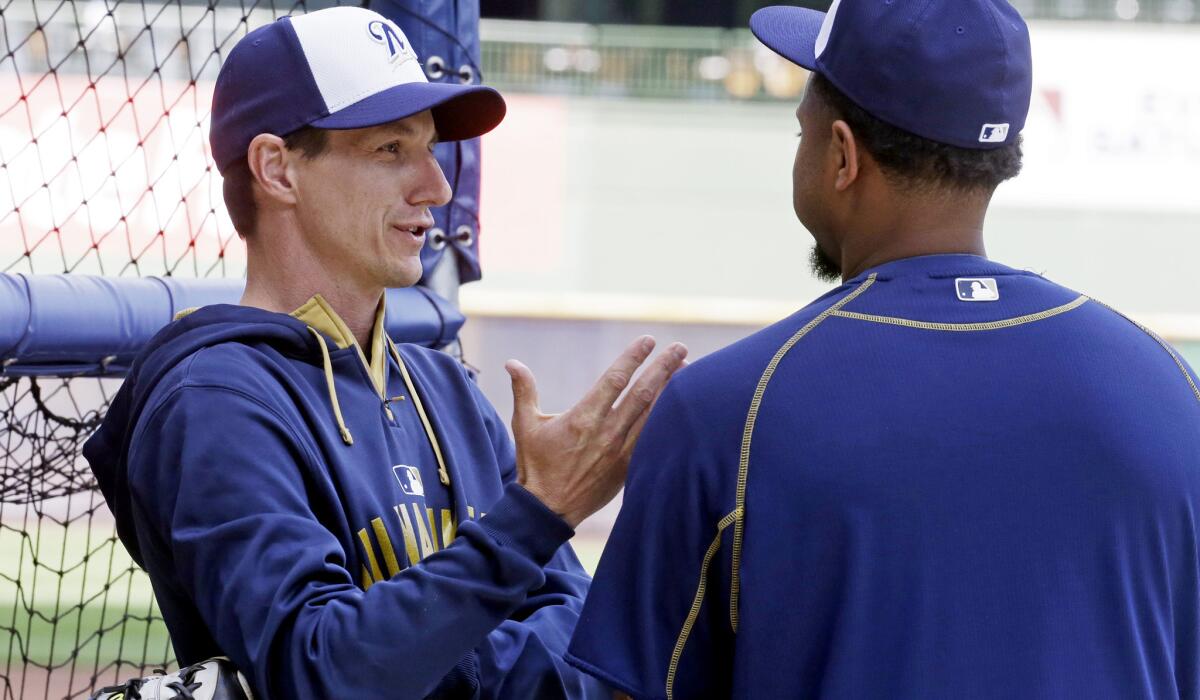 Brewers Manager Craig Counsell talks to catcher Martin Maldonado during batting practice before a game against the Los Angeles Dodgers on May 4.