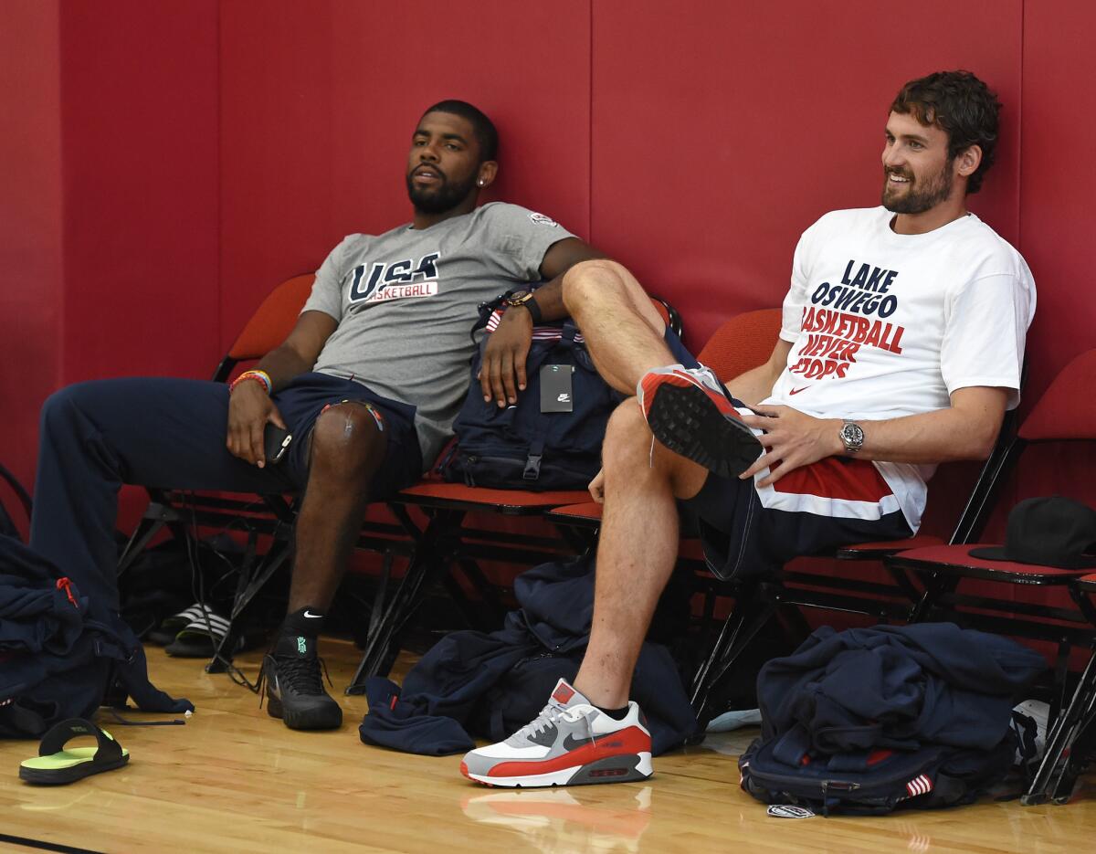 Cleveland Cavaliers guard Kyrie Irving and forward Kevin Love, right, look on during a USA Basketball practice on Aug. 11.