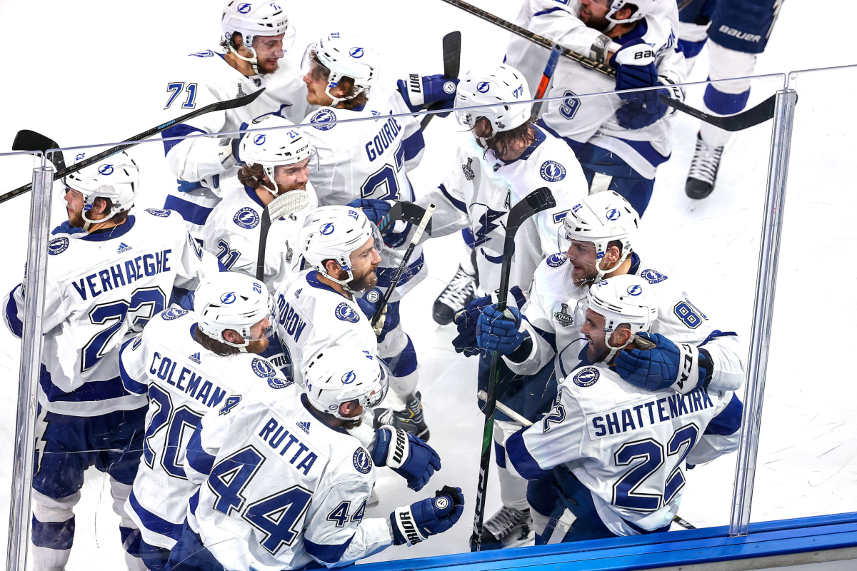 The Lightning's Kevin Shattenkirk (22) is mobbed by teammates after scoring the game-winning goal in overtime Sept. 25, 2020.