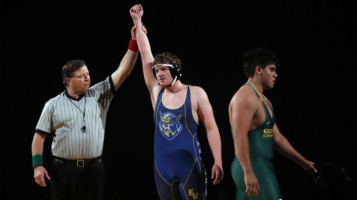 Fountain Valley High's Matthew Fee wins with a pin over Edison's Jovanni Page in the 220-pound weight class during a Sunset League dual meet on Wednesday.