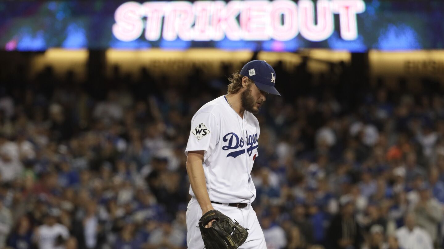 Clayton Kershaw walks off the field after striking out Yuli Gurriel to end the top of the third inning.
