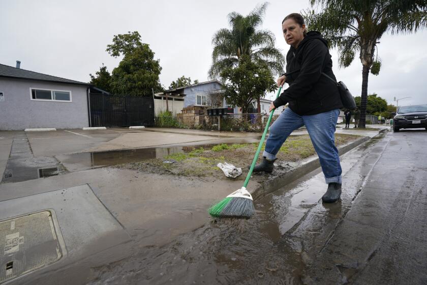 Ana Moran, 56 did her best to keep the water off her property.