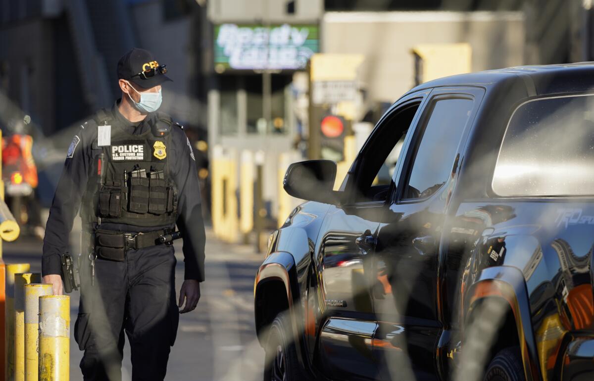 A U.S. Customs and Border Protection officer inspects a truck at the San Ysidro Port of Entry on Feb. 4, 2022.