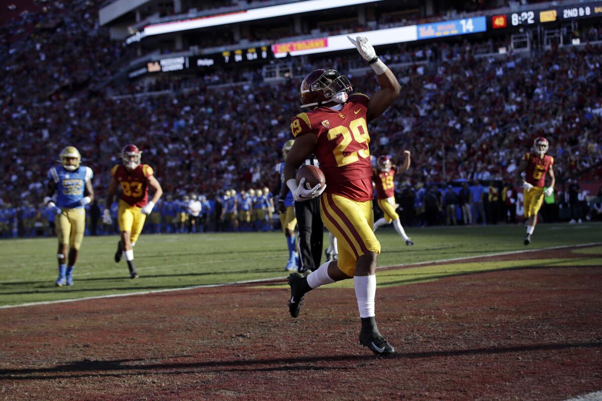 USC running back Vavae Malepeai celebrates as he scores a touchdown against UCLA.