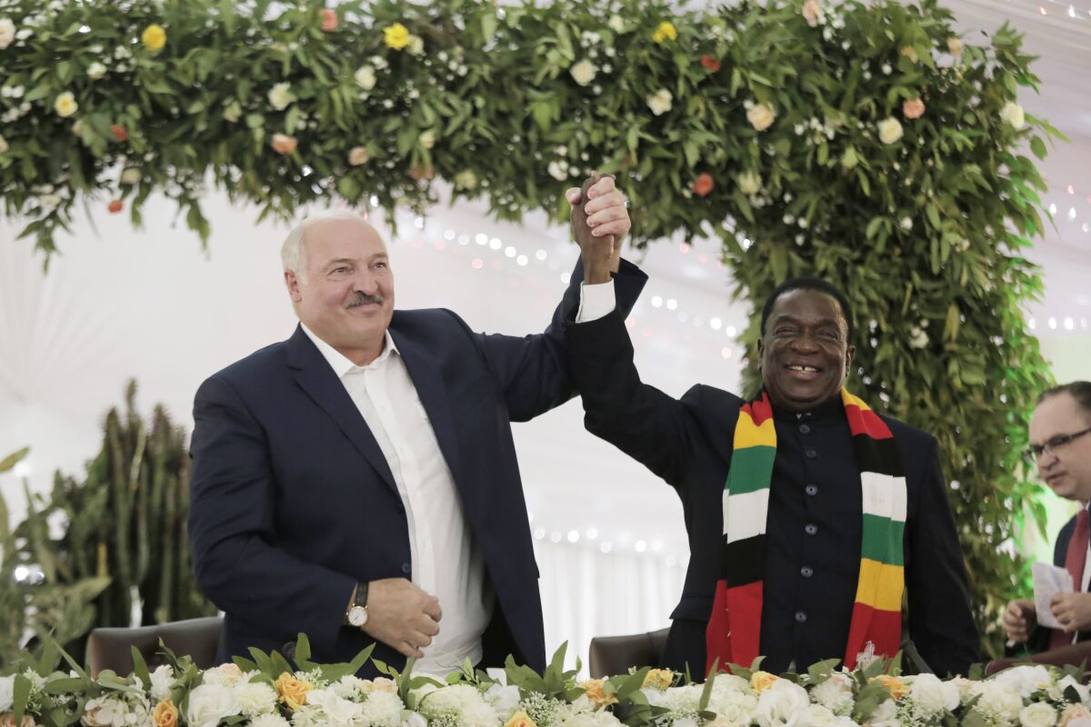 Belarus President Alexander Lukashenko, left, poses with Zimbabwean President Emmerson Mnangagwa at the State House in Harare, Tuesday, Jan, 31, 2023. Belarusian President Alexander Lukashenko has arrived in Zimbabwe to pomp and fanfare, in a visit that seeks to cement economic and political ties between the two countries that are both close allies of Russia. (AP Photo/Tsvangirayi Mukwazhi)
