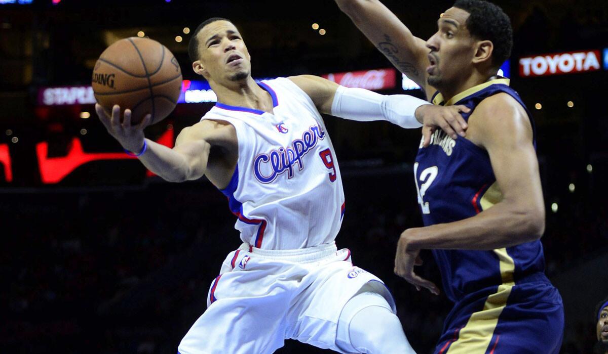 Clippers guard Jared Cunningham has his layup challenged by Pelicans center Alexis Ajinca during a game at Staples Center earlier this season.