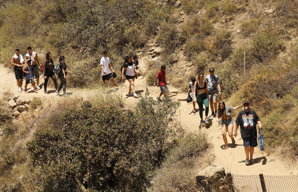 Crowds line the steep trail that leads to Paradise Falls in Thousand Oaks' Wildwood Regional Park