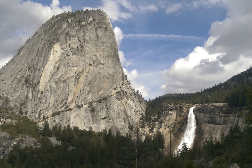 FILE - In this March 28, 2016, file photo provided by the National Park Service, water flows over the Nevada Fall near Liberty Cap as seen from the John Muir Trail in Yosemite National Park, Calif. The National Park Service says a man died after falling into a river at Yosemite National Park on Christmas Day. A government spokesman says rangers responding to a 911 call arrived on scene in less than an hour and provided medical aid, but the man died from a head injury. The park says an investigation into the death is taking longer than usual because of the partial government shutdown. (National Park Service via AP, File)