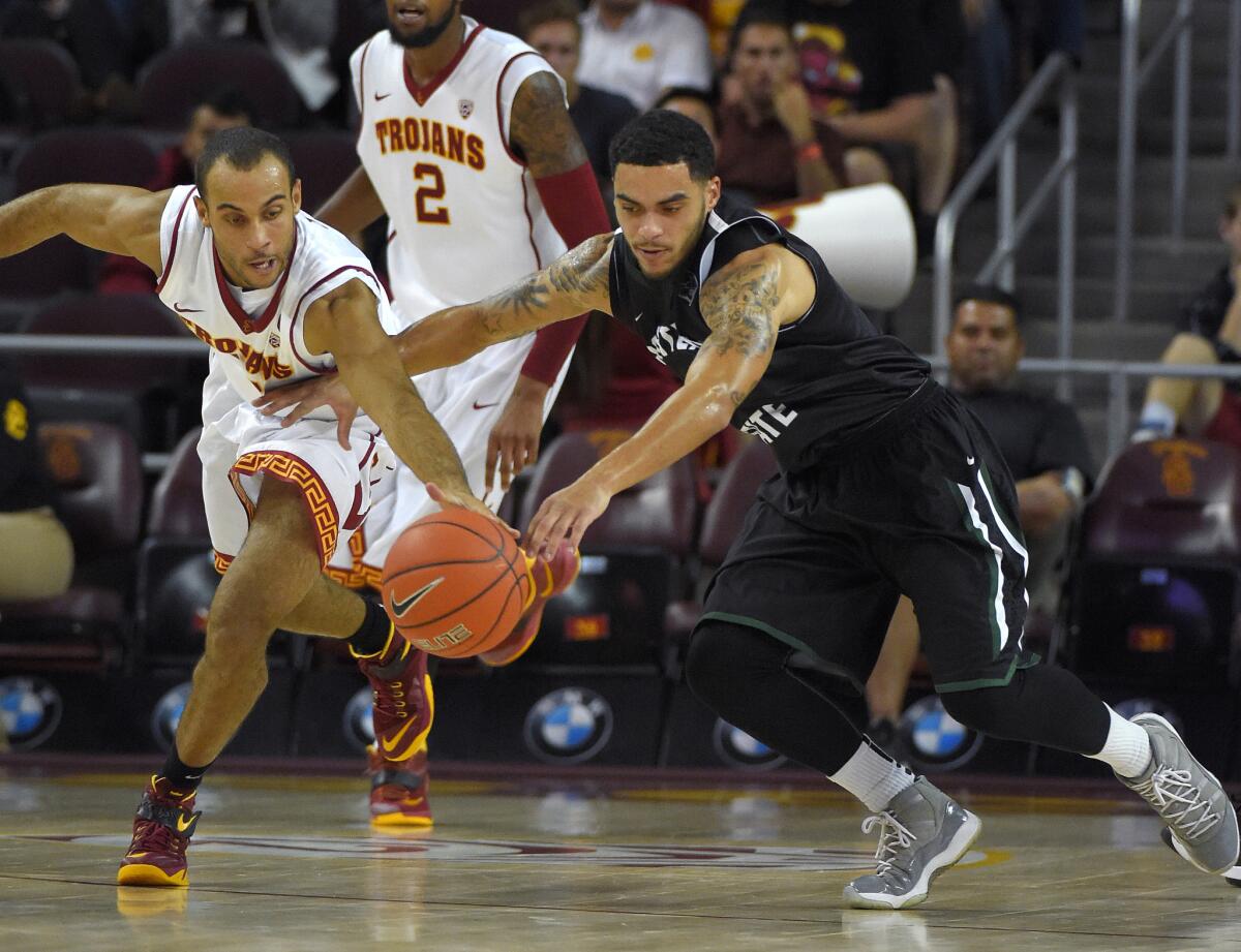 USC guard Julian Jacobs, left, and Portland State guard Gary Winston go after a loose ball on Nov. 15.