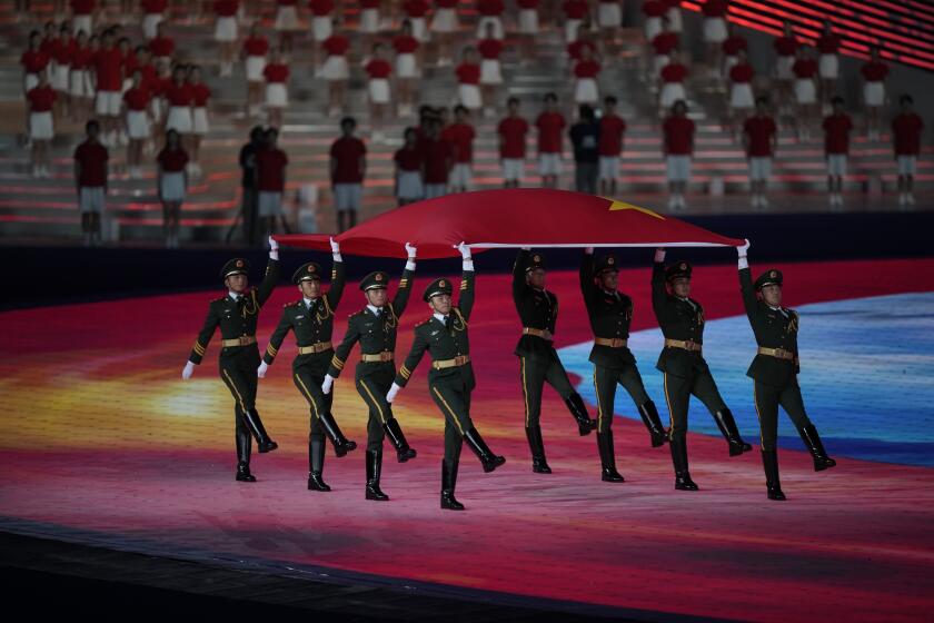 The national flag of China is carried in during the opening ceremony of the 19th Asian Games in Hangzhou, China, Saturday, Sept. 22, 2023. (AP Photo/Dita Alangkara)