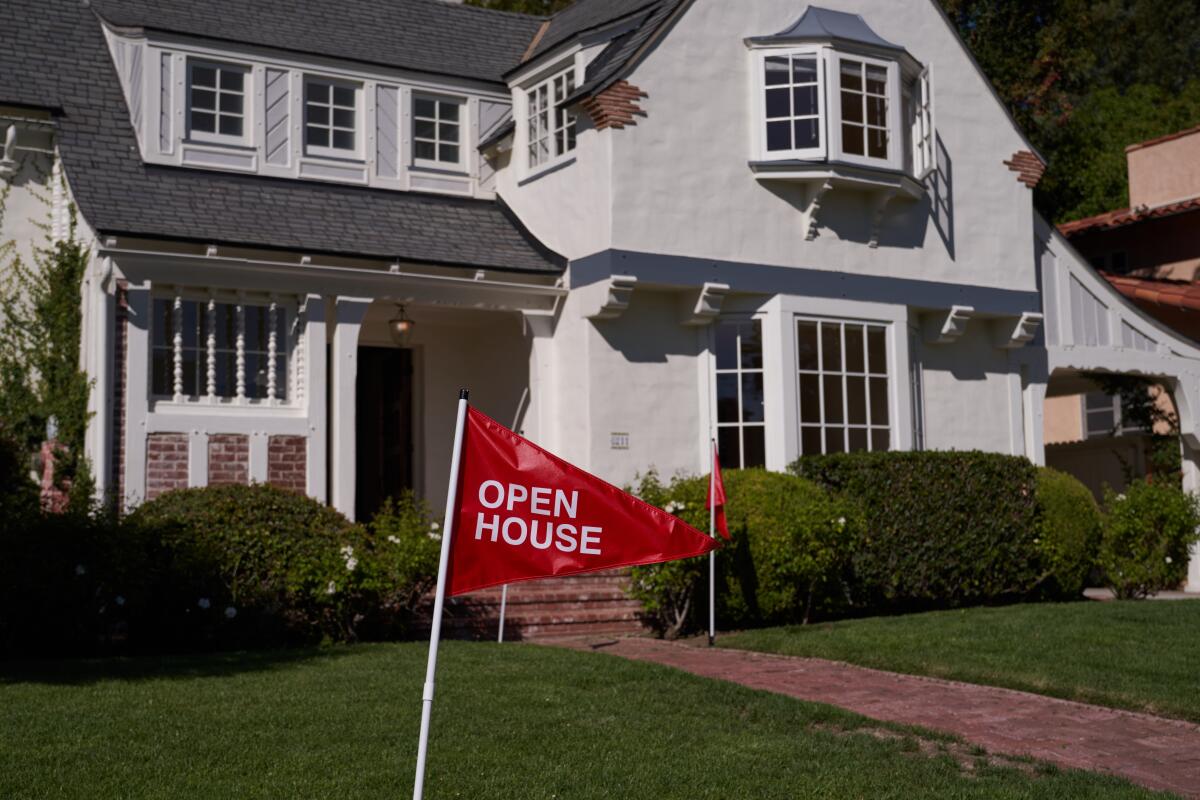 An open house flag is displayed outside a home