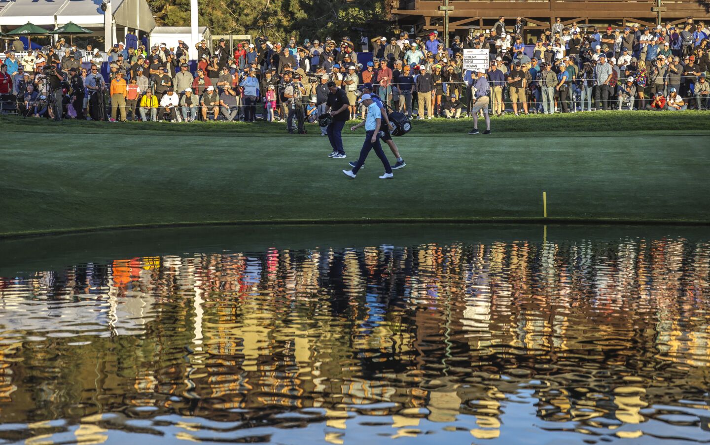 Justin Thomas walks past the pond at the South Course's 18th green during the third round of the Farmers Insurance Open on Jan. 28.