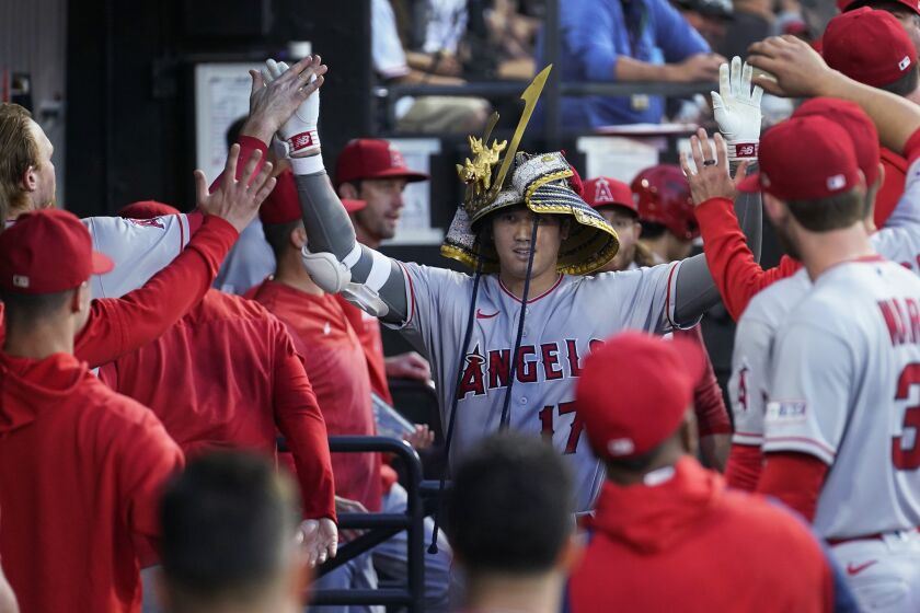 Los Angeles Angels' Shohei Ohtani is congratulated in the dugout after his home run off Chicago White Sox starting pitcher Lucas Giolito during the fourth inning of a baseball game Tuesday, May 30, 2023, in Chicago. (AP Photo/Charles Rex Arbogast)