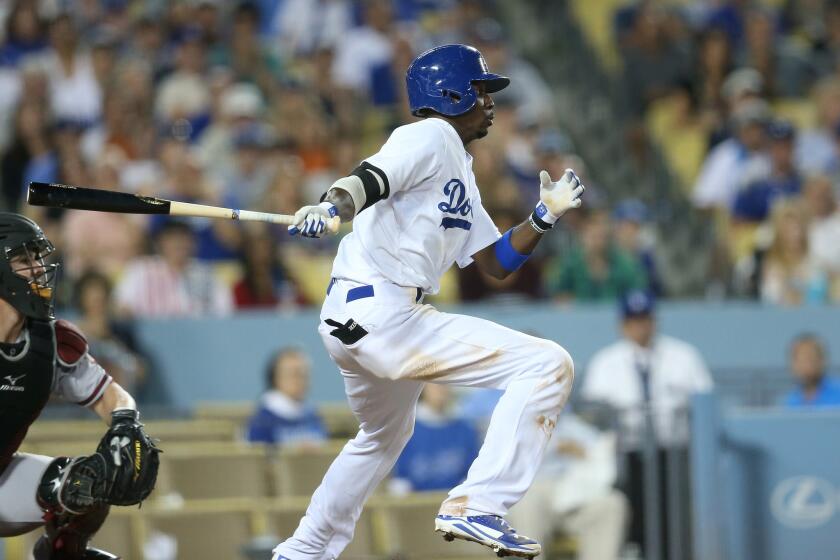 Dee Gordon hits an RBI single in the eighth inning of the Dodgers' 5-2 victory over Arizona on Saturday night.